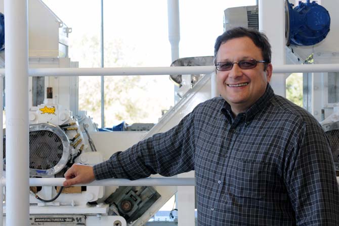 Director of the Louisiana Institute for Biofuels and Bioprocessing Vadim Kochergin stands Wednesday, Jan. 23, 2013 in front of new feedstock processing equipment at the Audubon Sugar Institute in St. Gabriel, La. The machine takes feedstock like sugarcane and turns it into syrup.
 