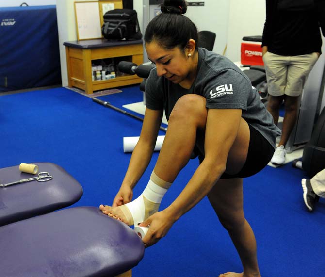 Ericka Garcia, a member of LSU's gymnastics team, wraps her ankle Monday, Jan. 28, 2013.
 