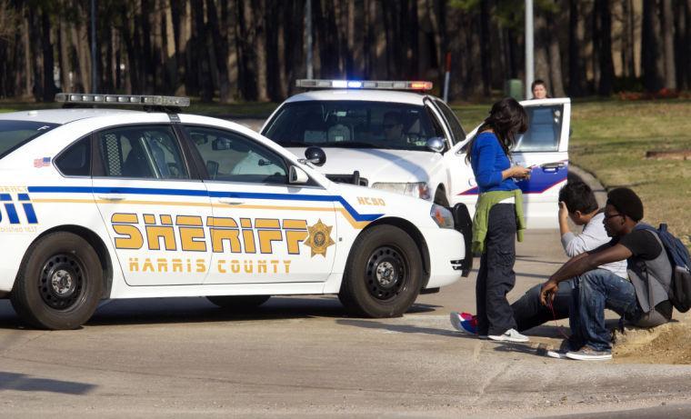 Students wait outside an entrance to the Lone Star College North Harris campus after a shooting on campus on Tuesday, Jan. 22, 2013 in Houston. The shooting wounded three people and sent students fleeing for safety as officials placed the campus on lockdown, officials said. Harris County Sheriff's Maj. Armando Tello said authorities had detained a person of interest. Police did not provide any details about the people who were wounded. (AP Photo/Patric Schneider)
 