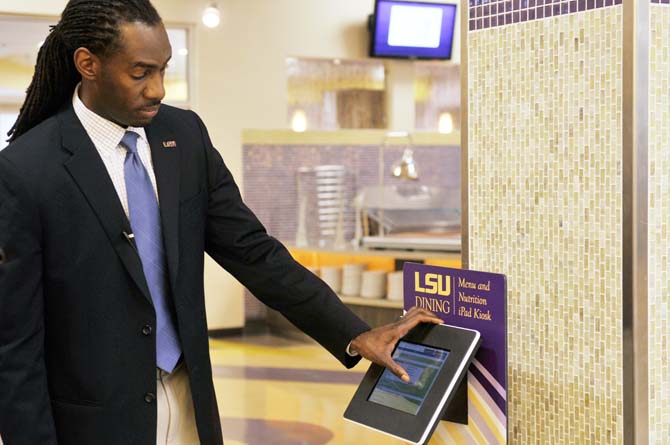 Dean Samuels, LSU's Dining and Marketing Director, demonstrates Friday, Jan. 11, how to use LSU's new dining app on a Kiosk in The 5. The app, which is exclusively available for Apple products, features a variety of options, including menus from LSU's dining halls, nutritional information, and an interactive map function. Students can now dowload the app from Apple's app store.
 