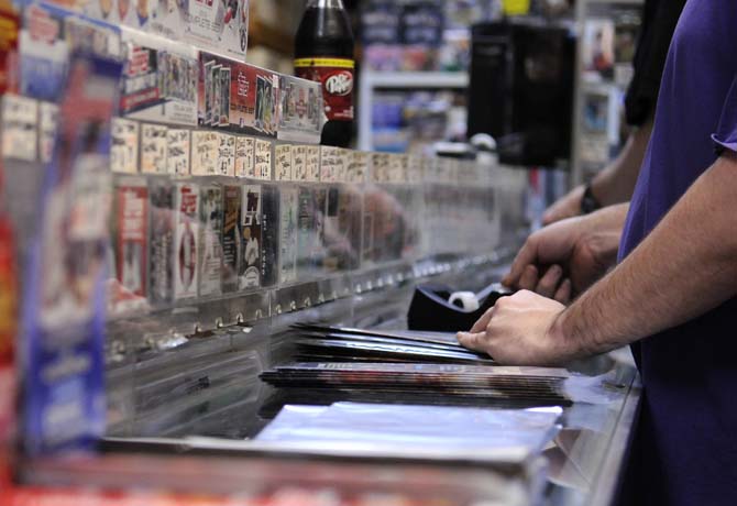 Workers label comic books on the counter in Louisiana's Double Play, Baton Rouge's only comic book shop, Tuesday, Jan. 29, 2013. The shop is located on S. Sherwood Forest Blvd.
 