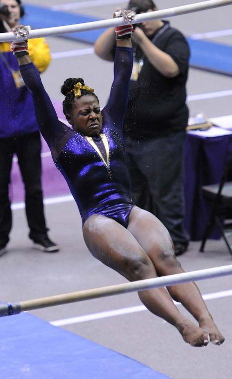 LSU sophomore all-around Lloimincia Hall spins on the uneven bars Friday, Jan. 11, 2013 during the Tiger's 196.875-196.575 win over Florida in the PMAC.
 