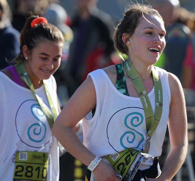 One of the Sole Sisters fellow runners smiles triumphantly after finishing the half marathon downtown on Jan. 20, 2013.
 