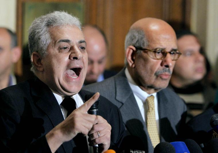 Former Egyptian presidential candidate Hamdeen Sabahi, left, speaks during a news conference following the meeting of the National Salvation Front as former director of the U.N.'s nuclear agency and Nobel peace laureate, Mohamed El Baradei, right, listens in Cairo, Monday, Jan. 28, 2013. The National Salvation Front, Egypt&#8217;s main opposition coalition, has rejected President Mohammed Morsi's call for dialogue to resolve the country&#8217;s political crisis, demanding that he first make deep concessions to break what they call the monopoly that Islamists have tried to impose on power. (AP Photo/Amr Nabil)
 