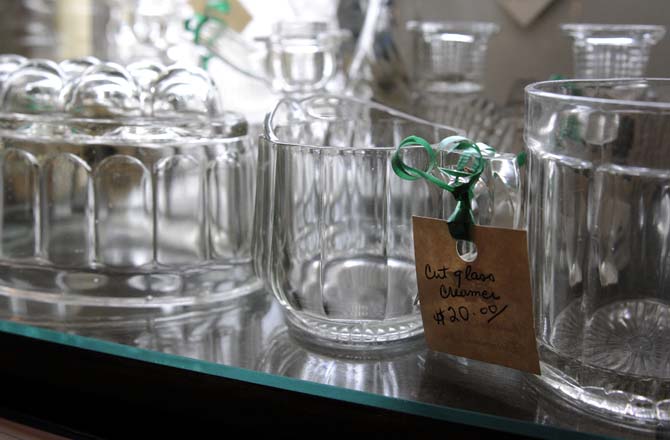 Some glass kitchen-ware sits on a shelf with the sun shining through in Circa 1857 on Jan. 28, 2013.
 