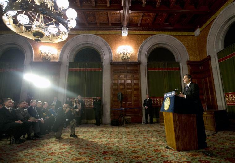 New York Gov. Andrew Cuomo speaks before signing New York's Secure Ammunition and Firearms Enforcement Act into law during a ceremony in the Red Room at the Capitol on Tuesday, Jan. 15, 2013, in Albany, N.Y. Jumping out ahead of Washington, New York enacted the nation's toughest gun restrictions Tuesday and the first since the Connecticut school shooting, including an expanded assault-weapon ban and mandatory background checks for buying ammunition. (AP Photo/Mike Groll)
 