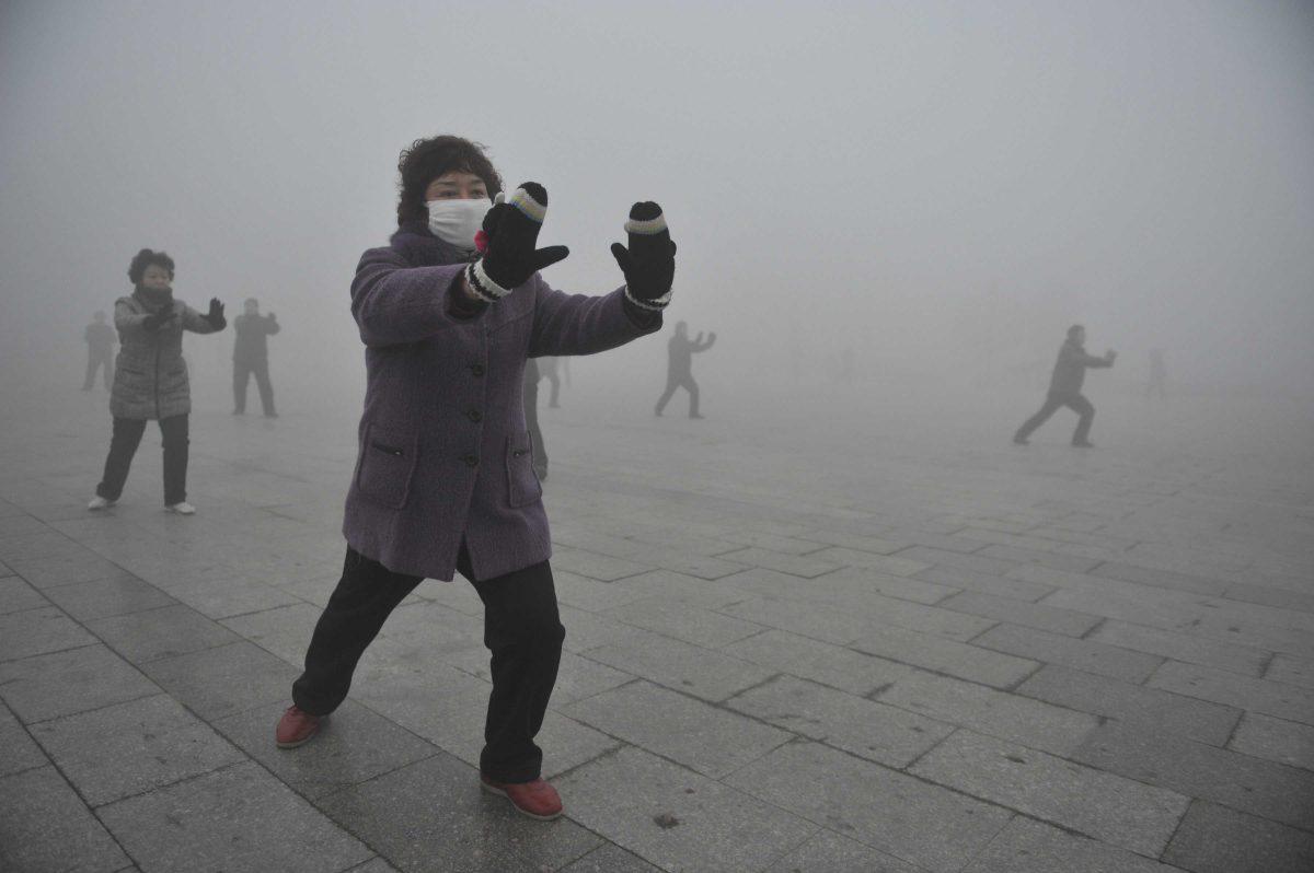 Retirees play Taichi during their morning exercise on a hazy day in Fuyang city, in central China's Anhui province, Monday Jan. 14, 2013. Air pollution is a major problem in China due to the country's rapid pace of industrialization, reliance on coal power, explosive growth in car ownership and disregard for environmental laws. (AP Photo) CHINA OUT