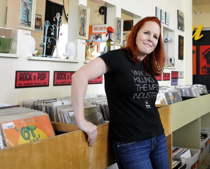 Atomic Pop Shop owner Kerry Beary stands Wednesday, Jan. 23, 2013 in front of the Rock and Pop record section on Government St.
 