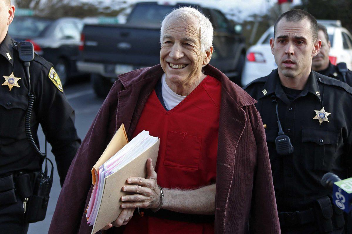 FILE - In this Jan. 10, 2013 file photo, former Penn State University assistant football coach Jerry Sandusky, center, arrives at the Centre County Courthouse for a post-sentence motion in Bellefonte, Pa. Sandusky lost a bid for a new trial Wednesday, Jan. 30, 2013 when Judge John Cleland rejected his argument that his lawyers were not given enough time to prepare for the three-week proceeding that ended with a 45-count guilty verdict. Sandusky is serving a 30- to 60-year prison sentence after being convicted in June of 45 counts of child sexual abuse. (AP Photo/Gene J. Puskar, File)