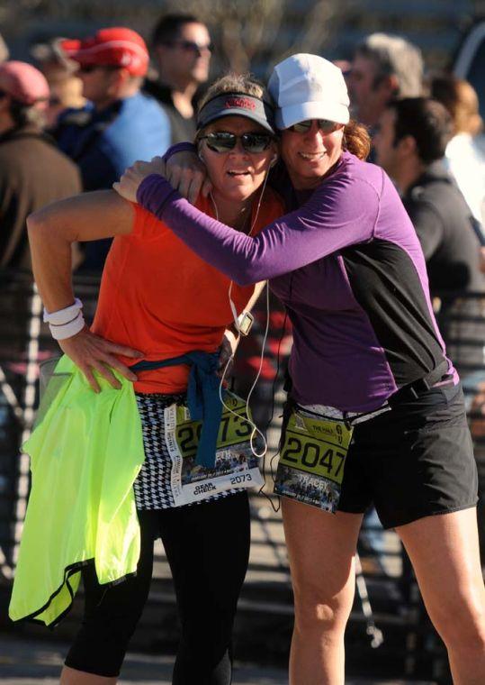 Two runners embrace immediately after finishing the half-marathon as a part of the Louisiana Marathon downtown on Jan. 20, 2013.
 