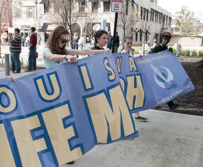 Protesters holding a banner Saturday, Jan. 12, 2013, lead other pro-life activists on a march that travelled from the Old State Capitol to the New State Capitol in downtown Baton Rouge, Louisiana.
 