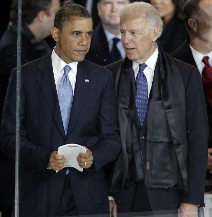 President Barack Obama talks with Vice President Joe Biden in the presidential box during the inaugural parade down Pennsylvania Avenue en route to the White House, Monday, Jan. 21, 2013, in Washington. Thousands marched during the 57th Presidential Inauguration parade after the ceremonial swearing-in of President Barack Obama. (AP Photo/Gerald Herbert)
 