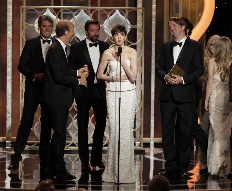 This image released by NBC shows actress Anne Hatheway, center, on stage with the cast and crew of "Les Miserables" after the film won for best musical or comedy during the 70th Annual Golden Globe Awards at the Beverly Hilton Hotel on Jan. 13, 2013, in Beverly Hills, Calif. (AP Photo/NBC, Paul Drinkwater)
 