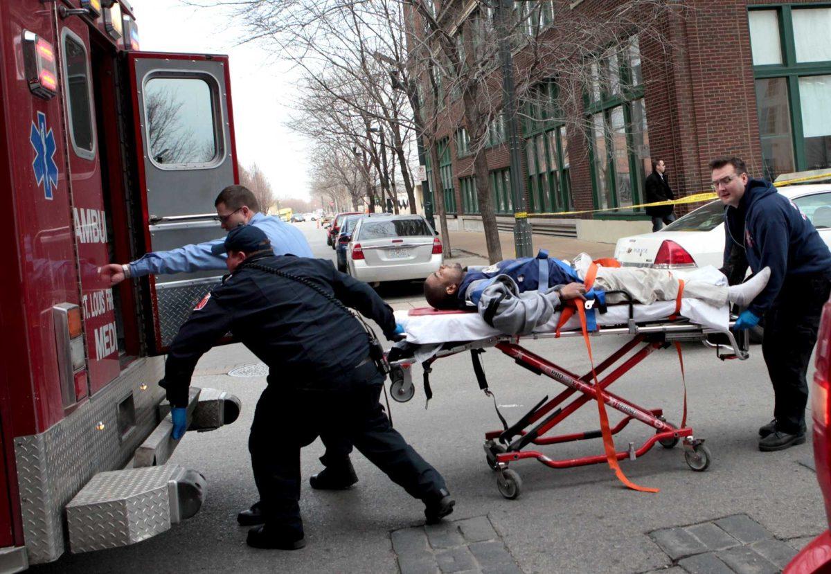 Police and emergency personnel transport a man to an ambulance after a shooting at Stephens Institute of Business and Arts on Washington Avenue in St. Louis on Tuesday, Jan. 15, 2013. A part-time student strode into the office of a longtime administrator at the school and shot the man in the chest, creating panic in the school before turning the gun on himself, police said. (AP Photo/St. Louis Post-Dispatch, David Carson) EDWARDSVILLE INTELLIGENCER OUT; THE ALTON TELEGRAPH OUT