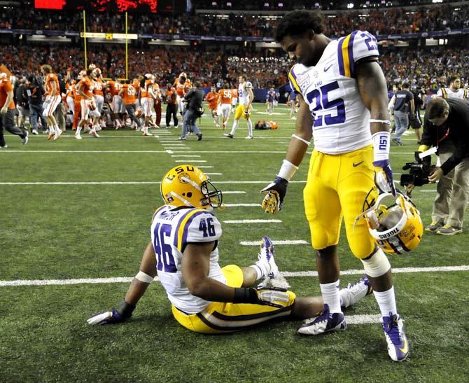 LSU freshman linebacker Kwon Alexander (25) extends a hand to junior linebacker Kevin Minter (46) Monday, Dec. 31, 2012 after the Tigers' 24-25 loss in the Chick-fil-A Bowl against Clemson in Atlanta, Ga.
 