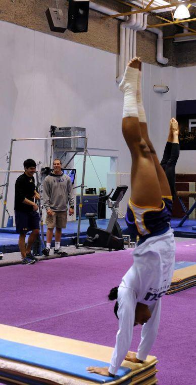 A member of LSU's gymnastics team practices handstands with both of her feet wrapped Monday, Jan. 28, 2013.
 