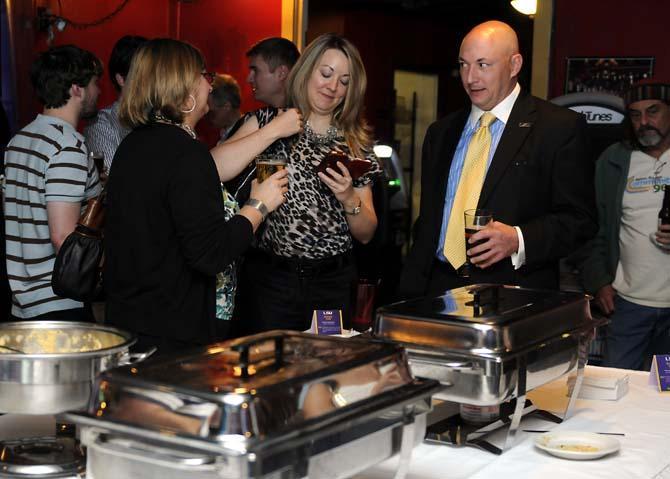 Attendees of Chelsea's Cafe's Science Cafe event eat, drink and socialize on Tuesday, Jan. 29, 2013 at Chelsea's Cafe.
 