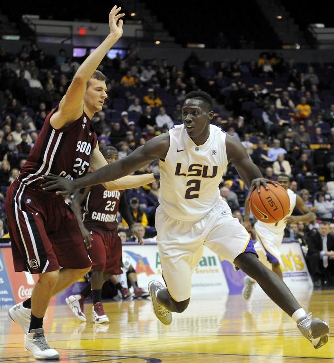 LSU sophomore forward Johnny O'Bryant III (2) dribbles past Wednesday, Jan. 16, 2013 University of South Carolina's freshman forward Mindaugas Kacinas (25) during the Tigers' 73-82 loss to the Gamecocks in the PMAC.
 