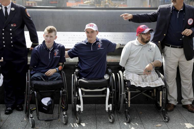 FILE - In this July 4, 2012 file photo, Army Sgt. Brendan Marrocco of Staten Island, N.Y., left, Marine Cpl. Todd Love of Atlanta, Ga., center, and Marine Cpl. Juan Dominguez of Deming, N.M., pose for a picture at the 9/11 Memorial in New York. Marrocco, 26, the first soldier to survive losing all four limbs in the Iraq war, has received a double-arm transplant in Baltimore. His father, Alex Marrocco, said Monday, Jan. 28, 2013 that his son had the operation on Dec. 18, 2012 at Johns Hopkins Hospital. (AP Photo/Seth Wenig, File)
 