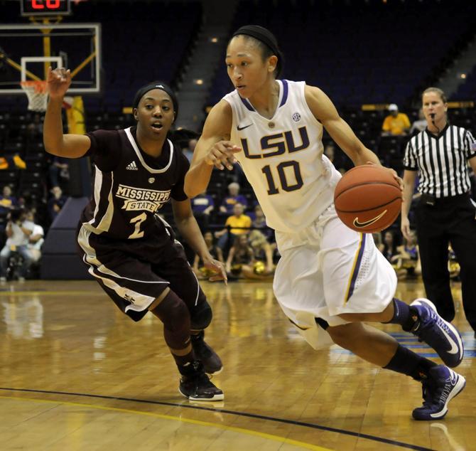 Senior guard Adrienne Webb (20) flys Sunday, Jan. 13, 2013 past Mississippi State senior guard Darriel Gaynor during the 62-42 victory over Mississippi State in the PMAC.
 