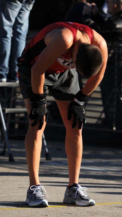 A runner stops to rest and catch his breath after finishing the half-marathon downtown on Jan. 20, 2013.
 