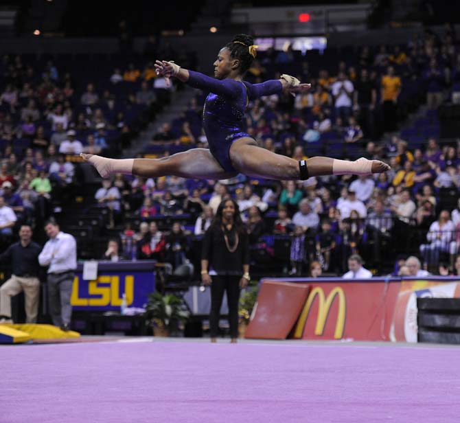 LSU sophomore all-around Lloimincia Hall leaps through the air in her floor routine Jan. 11, 2013 during the Tiger's 196.875-196.575 upset of the Florida Gators in the PMAC.
 