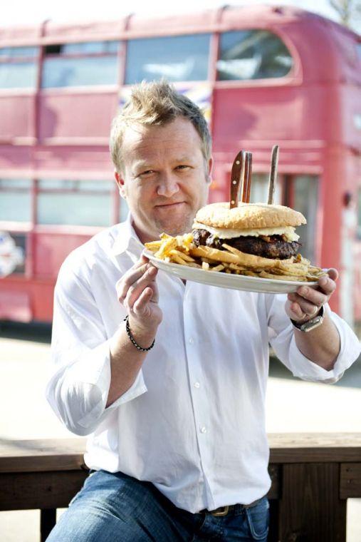 Co-owner of The Londoner, Luke Betts, holds the restaurant's "Big Ben" burger Wednesday, Jan. 23, 2013. The forty-ounce burger is on the house for patrons who are able to eat the meal in its entirety, but is $30.00 for those who are unable to.
 