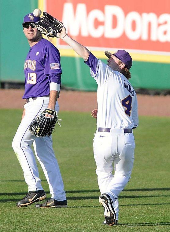 LSU senior outfielder Raph Rhymes (4) twists backward to catch a ball Jan. 25, 2013 during the Tiger's first preseaon practice in Alex Box Stadium.
 