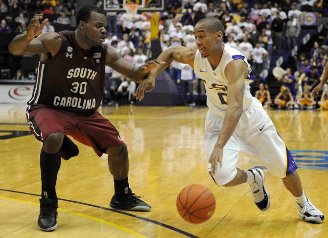 LSU senior guard Charles Carmouche (0) drives past Wednesday, Jan. 16, 2013 Univeristy of South Carolina's senior guard Lakeem Jackson (30) during the Tigers' 73-82 overtime loss to Camecocks in the PMAC.
 