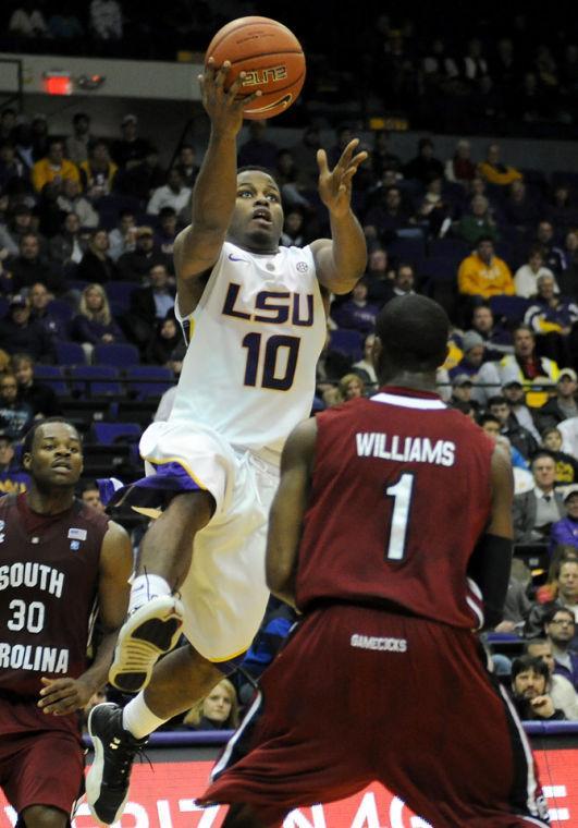 LSU junior guard Andre Stringer (10) scores Wednesday, Jan. 16, 2012 over University of South Carolina's junior guard Brenton Williams (1) in the Tigers 73-82 overtime loss to the Gamecocks in the PMAC.
 