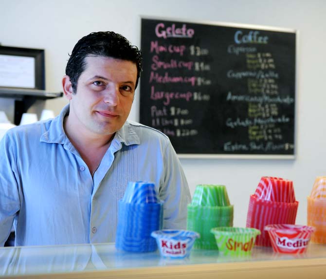 Mario Lozanov, owner of Bacio di Roma, stands behind the gelato counter inside his newly renovated restaurant on West Chimes Street on Saturday, Jan. 19.
 