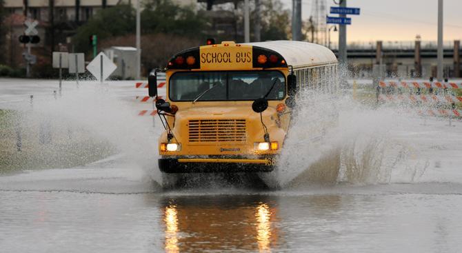 A bus storms Thursday, Jan. 10, 2013 into the flooded road near Burbank Drive and Nicholson Drive.
 