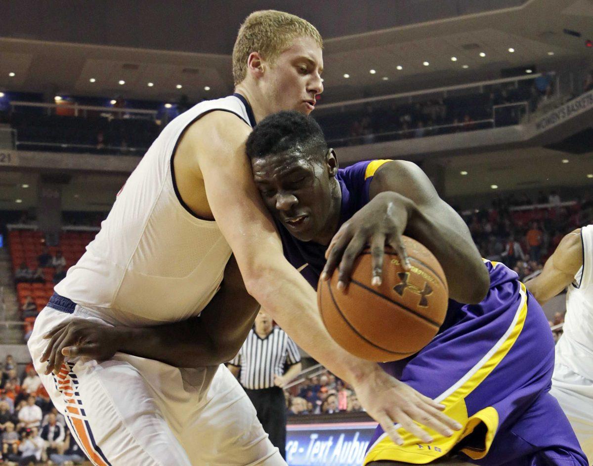 LSU forward Johnny O'Bryant III (2) is fouled as he drives to the basket by Auburn center Rob Chubb (41) in the first half of an NCAA college basketball game at Auburn Arena in Auburn, Ala., Wednesday, Jan. 9, 2013. (AP Photo/Dave Martin)