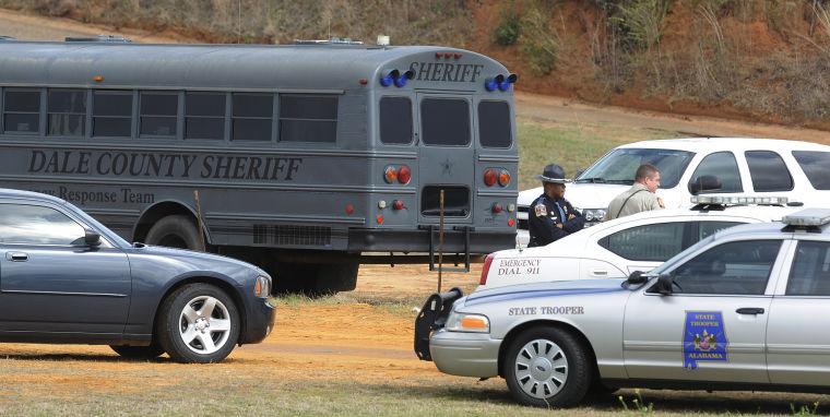 Police SWAT teams and hostage negotiators are gathered at standoff and hostage scene in Dale County near Midland City, Ala. on Wednesday Jan. 30, 2013. Authorities were locked in a standoff Wednesday with a gunman authorities say on Tuesday intercepted a school bus, killed the driver, snatched a 6-year-old boy and retreated into a bunker at his home in Alabama. (AP Photo/Montgomery Advertiser, Mickey Welsh)
 