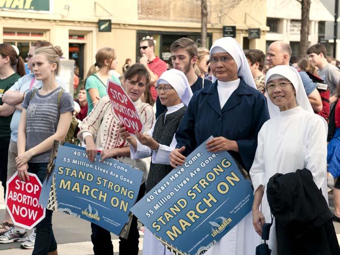 Nuns stand Saturday, Jan 12, 2013, among other protesters at Baton Rouge's 4th annual pro-life march.
 