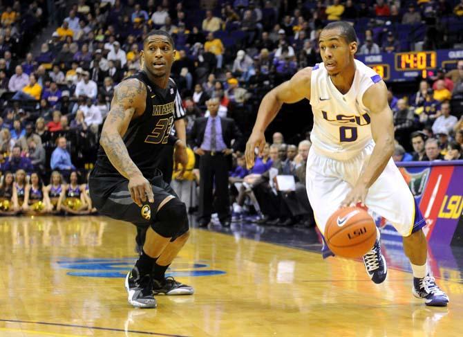 LSU senior guard Charles Carmouche (0) dribbles around Missouri junior guard Earnest Ross (33) during the Tigers' 73-70 victory against Mizzou Wednesday Jan. 30, 2013 in the PMAC.
 