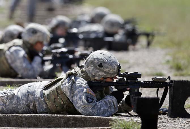 FILE - In this Sept. 18, 2012 file photo, female soldiers from 1st Brigade Combat Team, 101st Airborne Division train on a firing range while testing new body armor in Fort Campbell, Ky., in preparation for their deployment to Afghanistan. The Pentagon is lifting its ban on women serving in combat, opening hundreds of thousands of front-line positions and potentially elite commando jobs after generations of limits on their service, defense officials said Wednesday, Jan. 23, 2013. (AP Photo/Mark Humphrey, File)
 