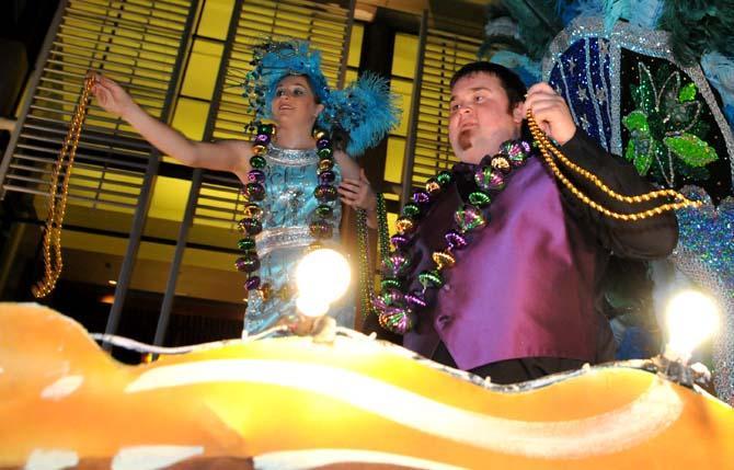 Members of the Krewe of Jupiter and Juno throw beads from their float Saturday Jan. 26, 2013 in front of the Baton Rouge River Center.
 