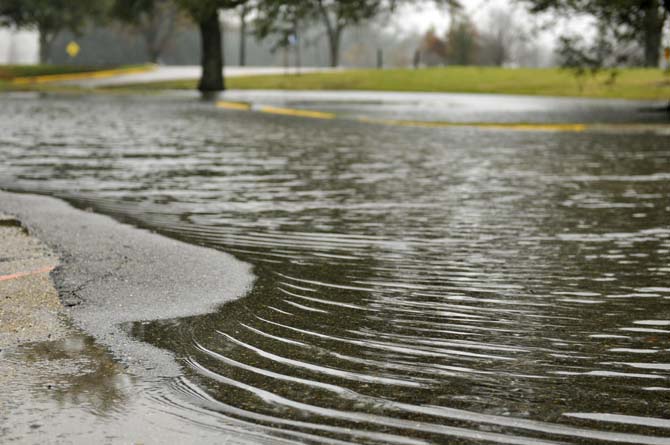 Waves wash up on a parking lot Jan. 9, 2013 near Nicholson Drive after a day and a half downpour. The heavy rains flooded several areas around campus.
 