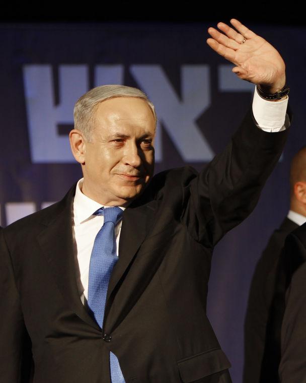 Israel's Prime Minister Benjamin Netanyahu greets his supporters in Tel Aviv, Israel, Wednesday, Jan. 23, 2013. According to exit polls, Netanyahu's Likud Party emerged as the largest faction in a hotly contested parliamentary election on Tuesday, positioning the hard-liner to serve a new term as prime minister.(AP Photo/Oded Balilty)
 