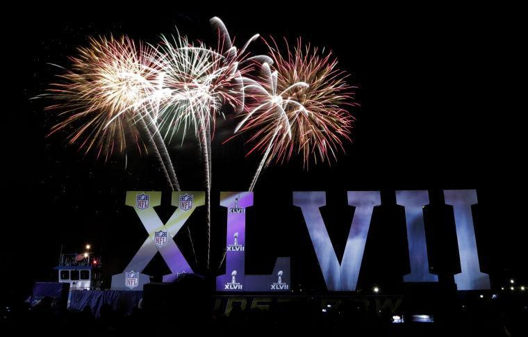 Fireworks explode as the NFL Super Bowl XLVII Roman numerals float on the Mississippi River Thursday, Jan. 31, 2013, in New Orleans. The city will host the football game between the San Francisco 49ers and Baltimore Ravens. (AP Photo/Charlie Riedel)
 