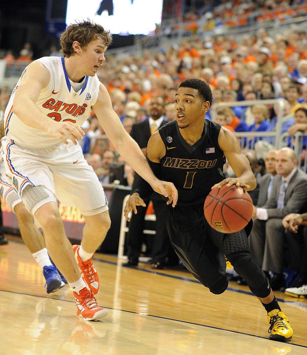 Missouri guard Phil Pressey (1) tries to get around Florida's Erik Murphy (33) during the second half of an NCAA college basketball game in Gainesville, Fla., Saturday, Jan. 19, 2013. Florida won 83-52. (AP Photo/Phil Sandlin)