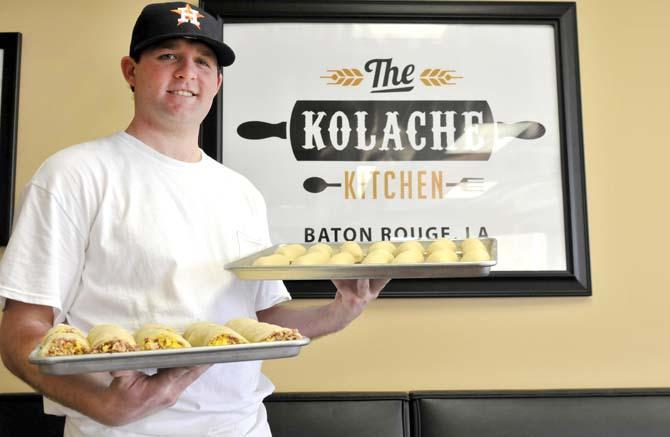 Kolache Kitchen owner Will Edwards poses with trays of prepared kolaches Saturday January 12, 2013 inside his restaurant on Nicholson Drive.
 