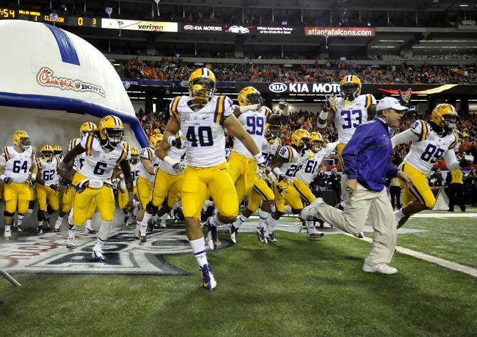 LSU head coach Les Miles leads the Tigers into the Georgia Dome Monday, Dec. 31, 2012 before the Chick-fil-A Bowl against Clemson in Atlanta, Ga.
 