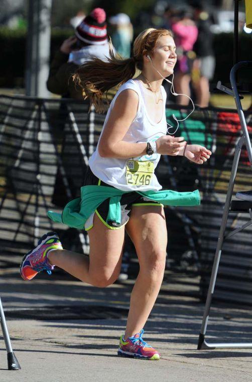 A runner closes her eyes as she crosses the finish line of the half-marathon for the Louisiana Marathon downtown on Jan. 20, 2013.
 