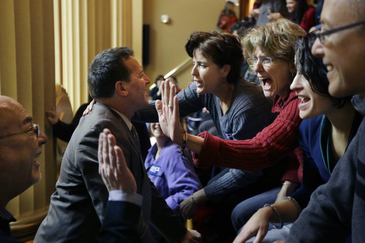 Rhode Island State Rep. Frank Ferri, D-Warwick, center left, and his partner Tony Caparco, far left, greet Wendy Baker, center right, and her partner Judy McDonnell, third from right, both of Providence, R.I., in the gallery of the House Chamber at the Statehouse, in Providence, Thursday, Jan. 24, 2013. Legislation to allow gay marriage in the state is headed for a vote Thursday in the House after being unanimously endorsed Tuesday by a legislative committee. (AP Photo/Steven Senne)