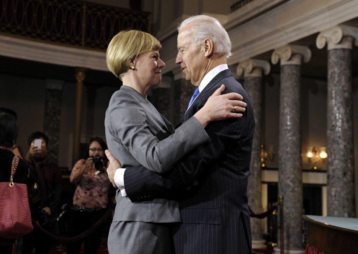 Sen. Tammy Baldwin, D-Wis. is hugged by Vice President Joe Biden during a mock swearing in ceremony on Capitol Hill in Washington, Thursday, Jan. 3, 2013, as the 113th Congress officially began. (AP Photo/Cliff Owen)