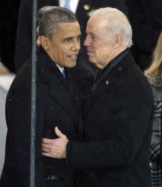 President Barack Obama, left, and Vice President Joe Biden talk inside the presidential box during the Inaugural parade, Monday, Jan. 21, 2013, in Washington. Thousands marched during the 57th Presidential Inauguration parade after the ceremonial swearing-in of President Barack Obama. (AP Photo/Gerald Herbert)
 