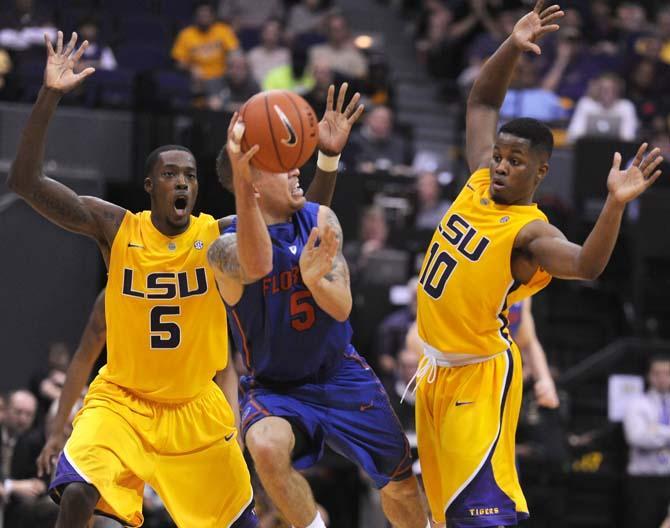 Shavon Coleman (5), LSU junior forward, and Andre Stringer (10), LSU junior guard, defend against Scottie Wilbekin (5), Florida junior guard, Saturday, Jan. 12 during the LSU vs. Florida game.
 