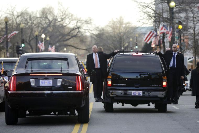 U.S. Secret Service agents who walked alongside the armored limousine of President Barack Obama and first lady Michelle Obama stand on running boards at the end of the parade at the 57th Presidential Inauguration in Washington, Monday, Jan. 21, 2013. (AP Photo/Charles Dharapak)
 